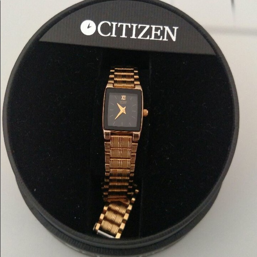 Square gold analog watch with gold link bracelet